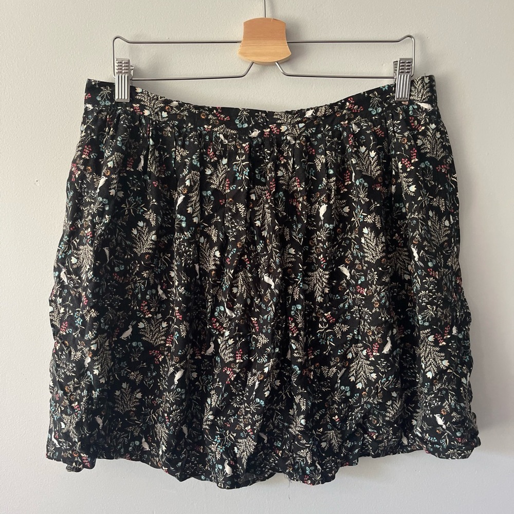 Black a line mini skirt with floral pattern containing rabbits.